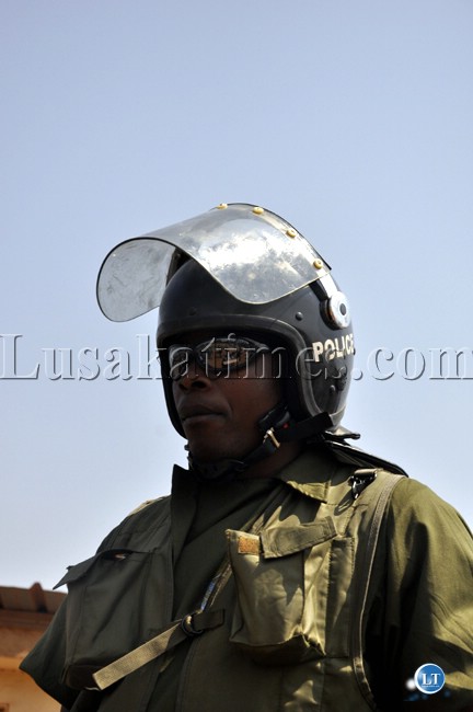 A policeman keeps vigil on UPND cadres outside the Lusaka magistrate court
