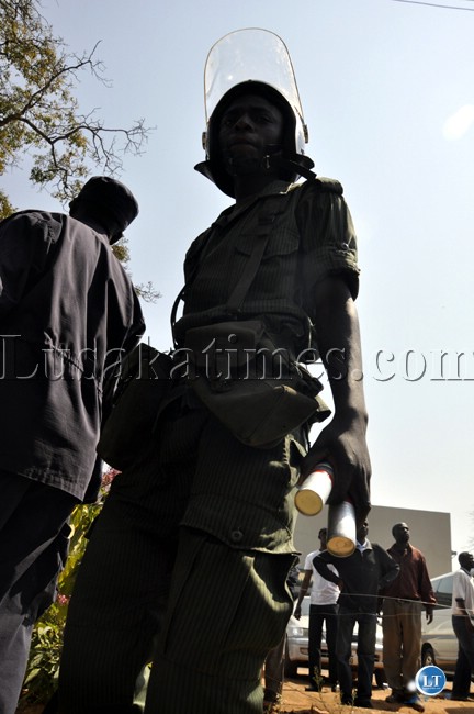 A policeman with teargas canisters at Woodlands police station where UPND leader Hakainde Hichilema was arrested.