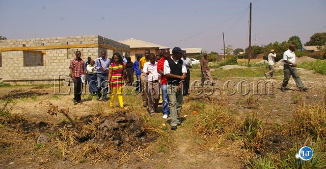 Kalulushi Mayor Howard Simpemba (l) with government and council officials inspect structures erected on the Nkana Water and Sewerage Company service lines Kalulushi Mayor Howard Simpemba (l) with government and council officials inspect structures erected on the Nkana Water and Sewerage Company service lines