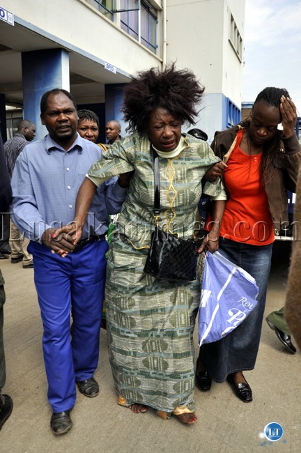 One of the injured women is helped out of the Lusaka Central Police Station One of the injured women is helped out of the Lusaka Central Police Station