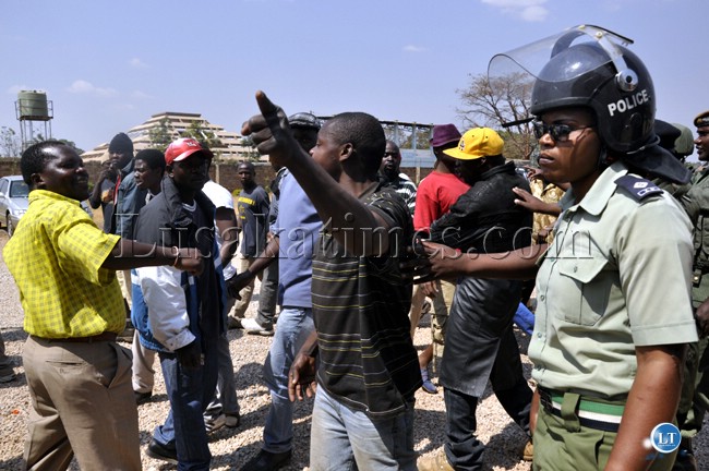 Police officers controlling PF cadres that had stormed the Lusaka magistrate court to beat UPND leader who was appearing in court