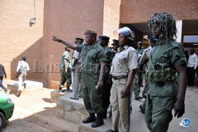 Police officers plot their operations outside the Lusaka magistrate court during the appearance of UPND leader Hakainde Hichilema in court