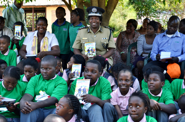 Inspector General of Police Stella Libongani and children drawn from various schools in Lusaka display copies of road safety books which were donated by the Zambia School of Driving in Lusaka Inspector General of Police Stella Libongani and children drawn from various schools in Lusaka display copies of road safety books which were donated by the Zambia School of Driving in Lusaka