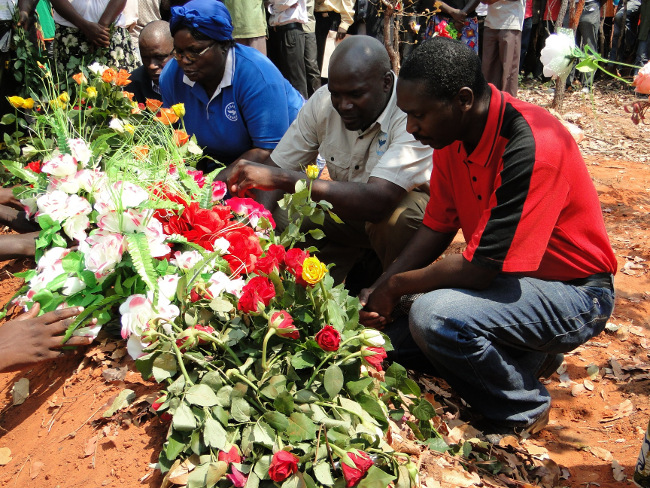 Zambia Congress of Trade Unions (ZCTU) president Leonard Hikaumba (r) with Civil Servants and Allied Workers Union of Zambia (CSAWUZ) president Davy Chiyobe (l) and a female senior union official laying wreaths on the grave of CSAWUZ national trustee late Smart Kajo at council cemetry in Chinsali district of Muchinga Province Zambia Congress of Trade Unions (ZCTU) president Leonard Hikaumba (r) with Civil Servants and Allied Workers Union of Zambia (CSAWUZ) president Davy Chiyobe (l) and a female senior union official laying wreaths on the grave of CSAWUZ national trustee late Smart Kajo at council cemetry in Chinsali district of Muchinga Province