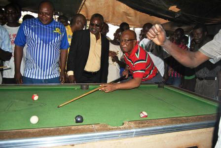 MMD leader Nevers Mumba (right) playing pool in Mufumbwe on Thursday while the party's Lusaka Province youth chairman Watson Mtonga (far left) looks on MMD leader Nevers Mumba (right) playing pool in Mufumbwe on Thursday while the party's Lusaka Province youth chairman Watson Mtonga (far left) looks on