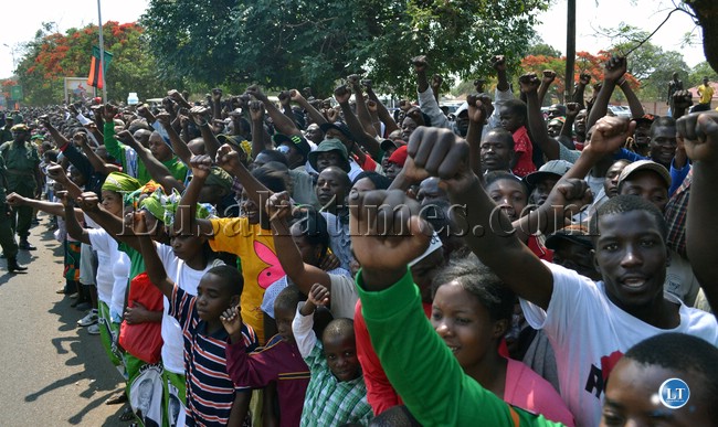 Jubilant members of the public cheer and wave at President Michael Sata when he arrived at the Freedom Statue Jubilant members of the public cheer and wave at President Michael Sata when he arrived at the Freedom Statue