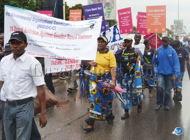 Women from various organisations carrying different placards denouncing Gender Based Violence during a march past to commemorate the 16 Days of Activism Against GBV in Lusaka