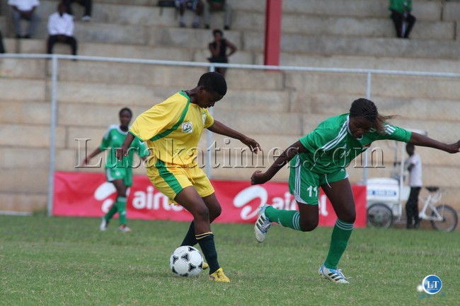 mitchel vanbe of zimbabwe in green fights for the ball with south africa maphuti manamelo in yellow at sunset