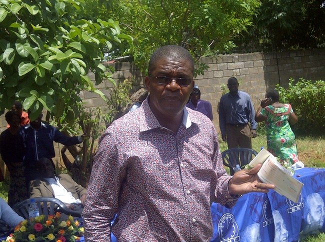 Berand Mpundu with Nevers Mumba's retirement cheque of 14 Ngwee