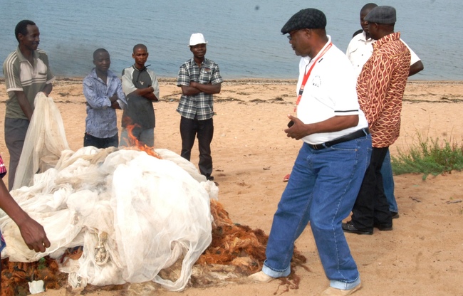LUAPULA Province Minister Benson Kapaya about to set ablaze fishing nets confiscated during the patrols to control fish ban by the Village Management Committe spearheaded by Senior Chief Puta of the Bwile people in Chienge District