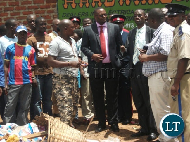 Eastern Province Permanent Secretary Emmanuel Mwamba (centre) talking to Acting Chipata Town Clerk Mwape Katemwe and Chipata District Commissioner Kalunga Zulu during the tour of Kapata Market in Chipata