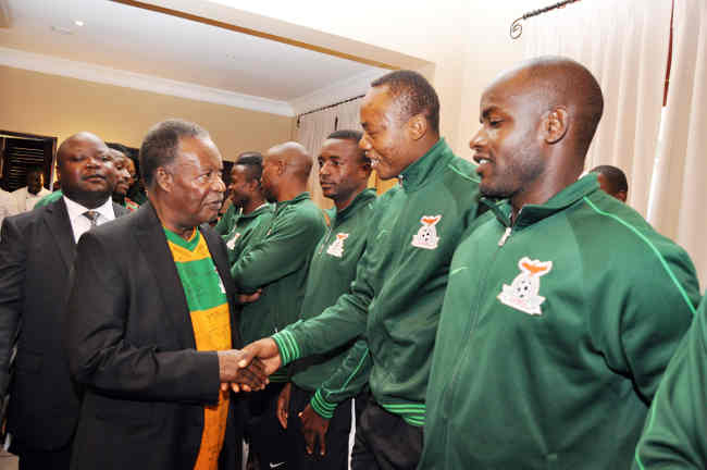 President Sata Shaking hands with Stopilla Sunzu when he visited the national Soccer Team