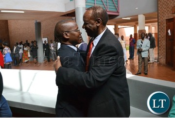 Former Information and Broadcasting Services Minister Ronnie Shikapwasha (right) and freelance journalist Chanda Chimba III hug at the Lusaka magistrate’s court complex