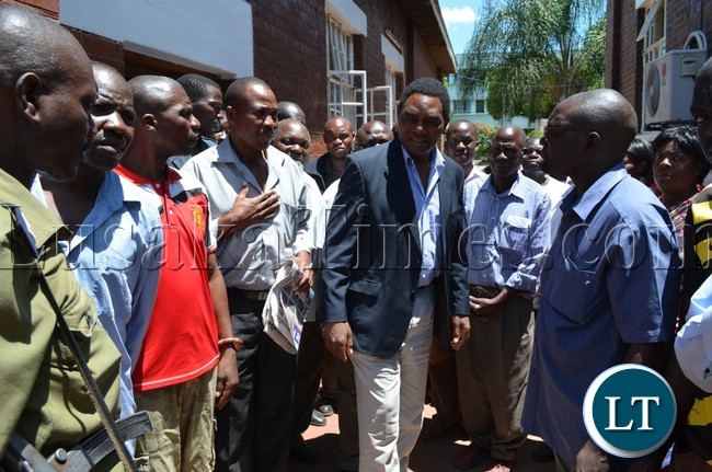 UPND president Hakainde Hichilema (middle) interacting with party cadres outside Livingstone Magistrate Court