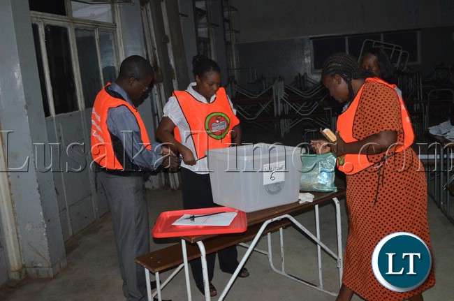 Electoral officers checking the ballot boxes
