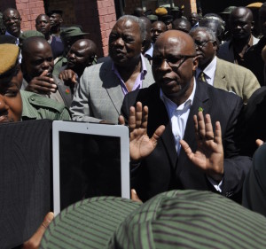 MMD president Nevers Mumba tries to control the crowd that gathered to show solidarity to Rupiah Banda at the DEC offices.