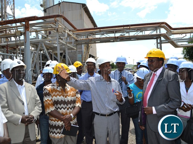 Nitrogen Chemicals of Zambia acting managing Director Zuze Banda (left) explains to Treasury to the Cabinet Fredson Yamba the operations and rehabilitation works currently taking place at the Kafue plant. This was when the Ministry of Finance and National Planning visited the plant on Wednesday to see how the company is utilizing the funds given to them by Government in August 2012