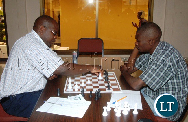 FORMER Zambia National Broadcasting Corporation 1991 Chess Champion Dr. Chitalu Chilufya who is also Mansa's Henry Courtyard Lodge proprietor and Tournament sponsor makes a move against Malembeka Chumfwa during the National Team Chess Trials Tournament in Mansa