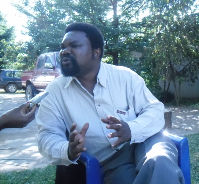 Dr Canisius Banda talking to journalists
