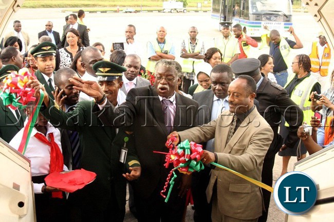 Ethiopian Airline Director - Advertising & Promotions Mengistu Adelahu (right) with Ndola DC Rabby Chanda, cuts a ribbon to mark the official launch of an Ethiopian Airline flight to Ndola.