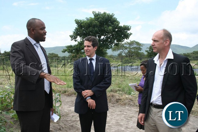 EASTERN Province Minister, Malozo Sichone, charts with USAID Deputy Mission Director, Ryan Washburn (middle) and Commercial Agribusiness Sustainable Horticulture (CASH) Chief of party, Dr. Petrus Langenhoven during the tour of horticultural demonstration plots in Chipata