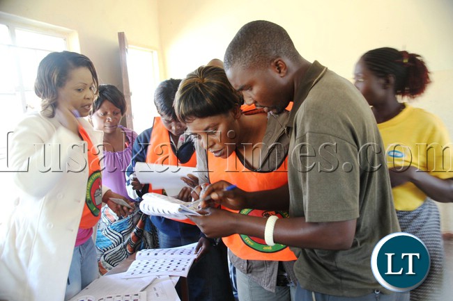 Elections officials verifying details of a voter during elections at matilyo polling station in Kapiri Mposhi