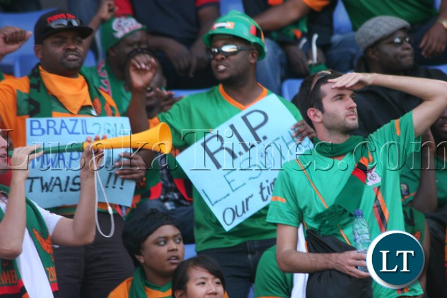 Chipolopolo fan who rightly predicted defeat for Lesotho holds up a placard