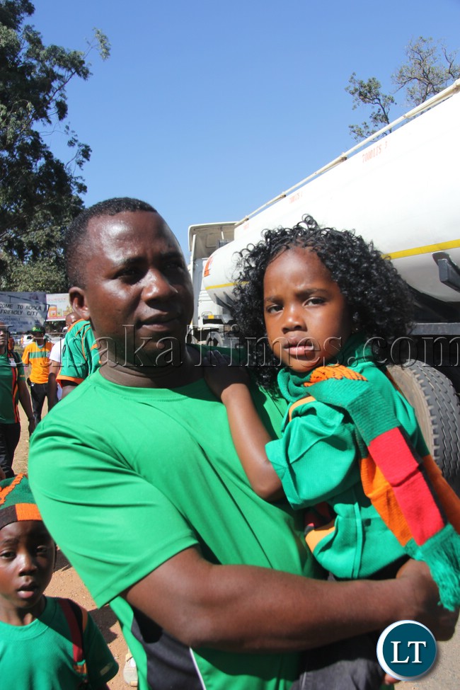 A dad and his daughter at the soccer match
