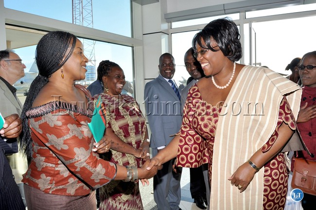 First Lady Dr Christine Kaseba being welcomed by Zambian Embassy's First Secretary Administration Annie Musonda (L) on arrival at Maputo International Airport