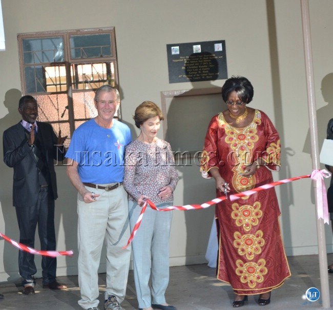 Former United States of America President George W. Bush (second from far left), his wife Laura (second from far right) and First lady Christine Kaseba (far right) cutting a ribbon to launch the newly refurbished Mosi-oa-tunya Clinic in Livingstone
