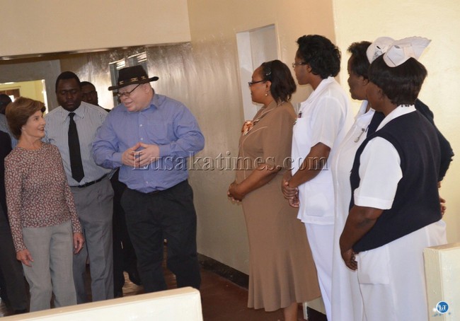 Livingstone General Hospital Head of Pediatrics and Child Health, who is also the director for the Hospital’s Pediatric Center for Excellence, Dr.Robert Fubisha (putting on a hat) introduces George Bush’s wife Laura (far left) to nurses at the centre