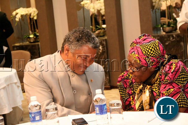 Kabwata MP Hon. Given Lubinda (l) discussing with Human Rights Commisioner Isabel Katongo Simukonda during the Launch of the Parliamentary Caucus on Children Strategic Plan 2012-2016 at Raddison blu Hotel