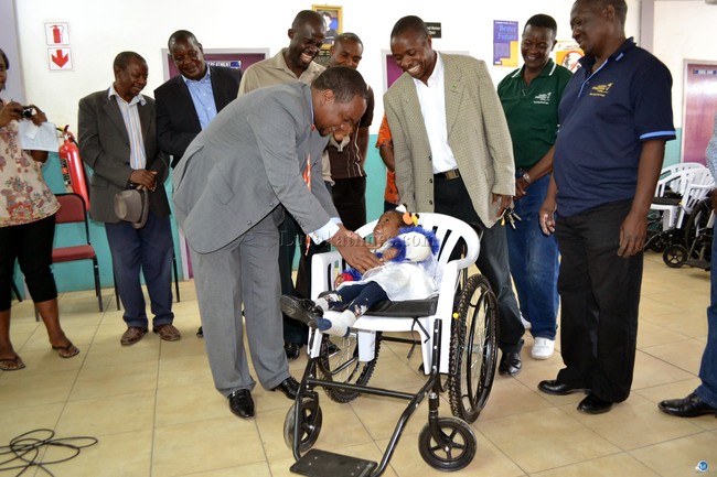 Matero Member of Parliament Miles Sampa talks to one of the children with disabilities who benefitted from a donation of 60 wheel chairs donated by Children International which he handed over to children in George Township in Lusaka recently