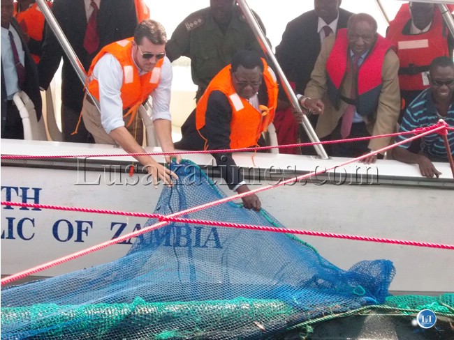 FINANCE Minister Alexander Chikwanda (third from right) looking at the caged fish under the Kambashe Bream Fisheries pilot project which he launched in Chilubi District in Northern Province