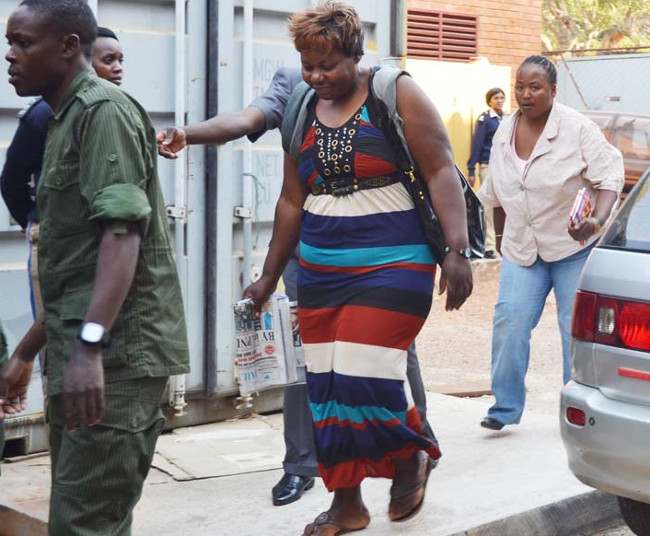 JASMINE Beauty Parlour proprietor Beatrice Hangwende (striped dress) heading to a waiting Mitsubishi Fuso bus yesterday shortly after the Lusaka High Court sentenced her to death for murder. Behind her is Mary Moyo who was acquitted
