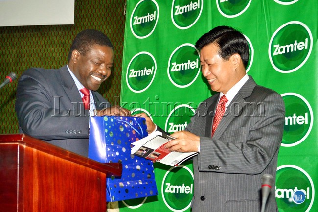 Chinese Ambassador to Zambia Zhou Yuxiao is presented with a book, ‘Achievement Values for Young Adults,’ by Teen Vision Trust Chairperson Chibamba Kanyama at the 6th Creating the Future Conference in Lusaka.