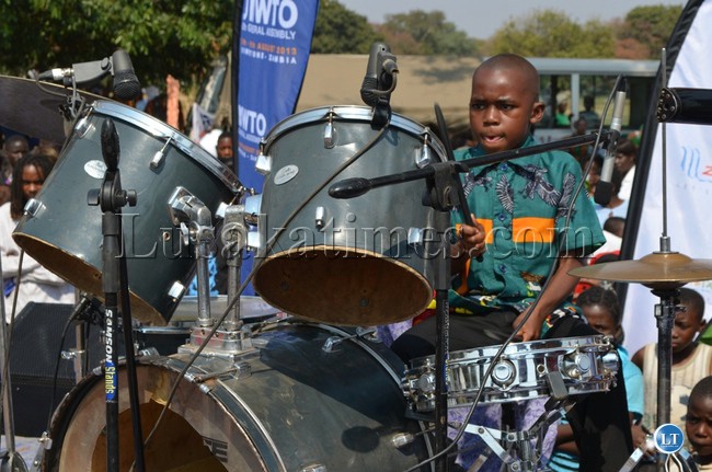 A six year old Livingstone boy gives the crowd stunning performance on the drums as Tourism and Arts Minister Sylvia Masebo watches during the Livingstone arts and cultural festival at Livingstone Golf Club last Saturday in readiness for the UNWTO general assembly.