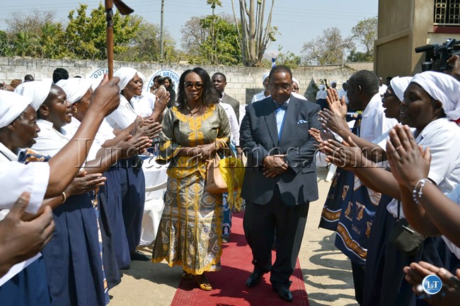 Former Defense Minister Geoffrey Mwamba and his wife Chama are welcomed by Buomba choir on arrival at a fundraising braai at St Patrick’s Catholic Parish in Lusaka