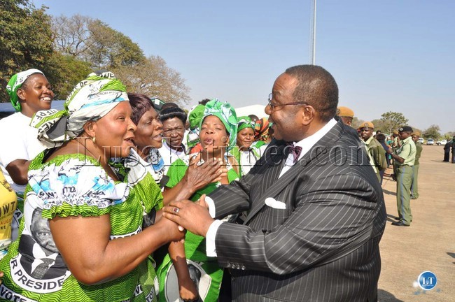 Defence minister Geoffrey Mwamba greets PF cadres shortly before President Michael Sata arrived at Harry Mwaanga Nkumbula International Airport for the opening of the UNWTO 20th General Assembly -Picture and caption by THOMAS NSAMA