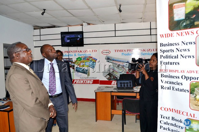 Information and Broadcasting Services Deputy Minister Mwansa Kapeya is taken on a tour of the Times Printpak pavilion my Times Printpak Marketing Manager Mark Nyasulu at the Zambia Agriculture and Commercial Show in Lusaka