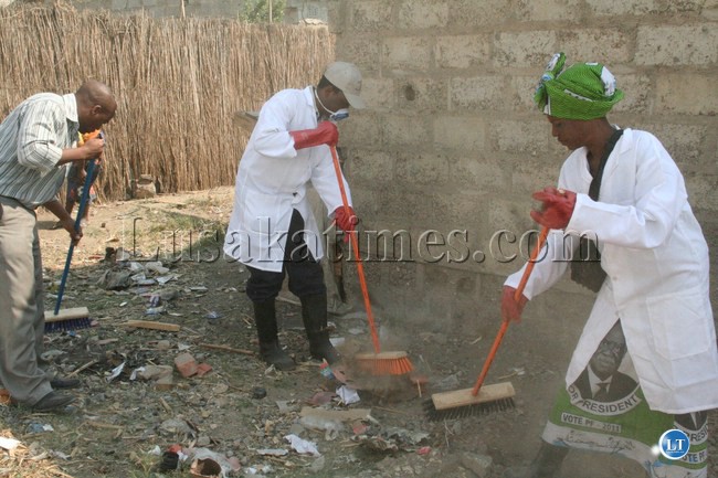 Local Government Deputy Minister Nicholas Banda (c) helps in the cleaning during the launch of the ''Cleaning Constituency Exercise'' in Matero, Lusaka, August 15, 2013.