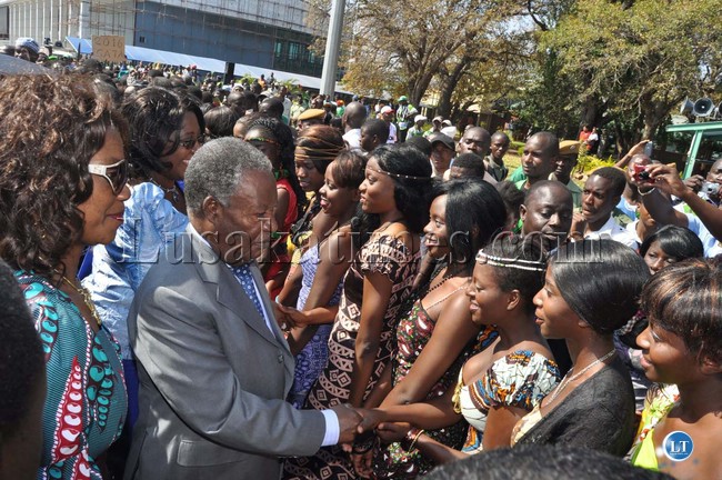 PRESIDENT Michael Sata and First Lady Christine Kaseba (behind) greet 2013 contestant for Miss Tourism beauty pageants at Harry Mwaanga Nkumbula International Airport in Livingstone yesterday. On the left is Tourism and Arts Minister Sylvia Masebo.