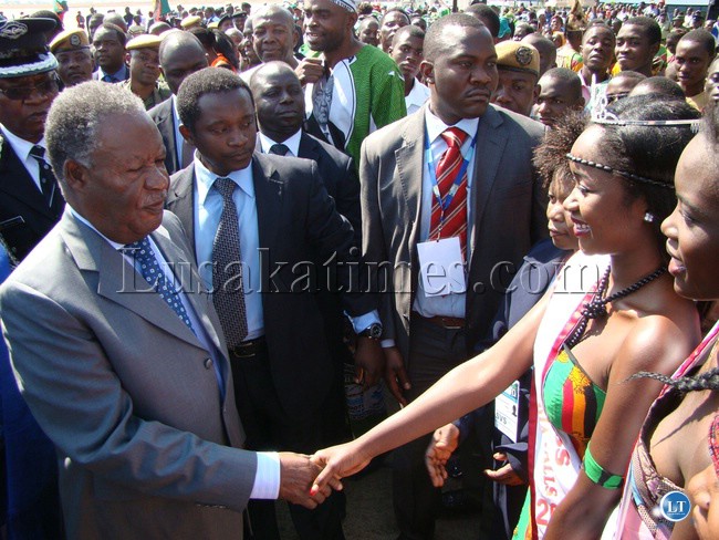PRESIDENT Michael Sata shakes hands with a 21 year old Miss Tourism 2013 Yolanda Musenge at Harry Mwaanga Nkumbula International Airport in Livingstone yesterday. The President was in the city enroot to Victoria Falls town in Zimbabwe for official opening of United Nations World Tourism Organisation (UNWTO) 20th general assembly.