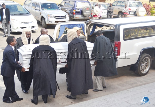 PALL bearers carry the casket of retired Supreme Court Judge Sandson Silomba at the Supreme Court in Lusaka