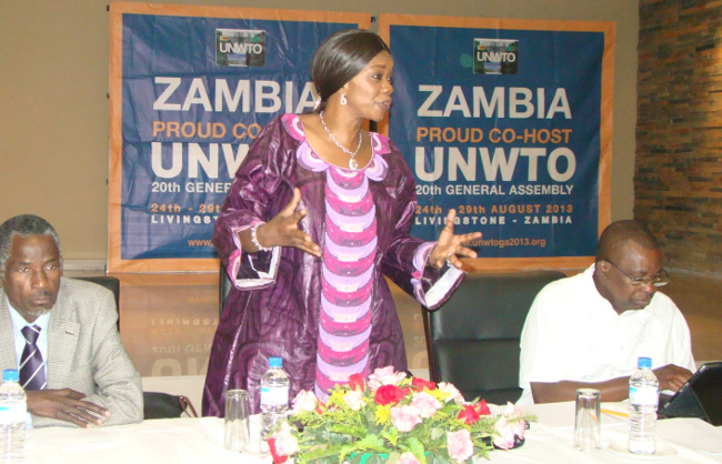 TOURISM and Arts Minister Sylvia Masebo speaking during the United Nations World Organisation (UNWTO) general assembly local and National organism committee at Courtyard Hotel in Livingstone yesterday. On her right is Southern Province Permanent Secretary Bernard Namachila and Director of Tourism Ambassador Albert Muchanga (left)