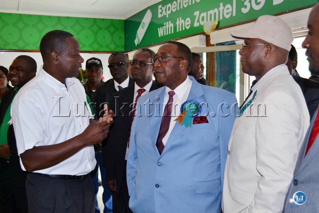 Defense Minister Geoffrey Mwamba (centre) and Agriculture and Co-operatives Minister Bob Sichinga (right) listen to ZAMTEL Managing Director Mupanga Mwanakatwe (left) when they visited the Zamtel pavilion at the Zambia Agriculture and Commercial Show in Lusaka.