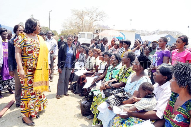 First Lady Dr Christine Kaseba speaks with women waiting for cervical Cancer screening in Mkushi where she is offering medical Services on September 9,2013-Picture by THOMAS NSAMA