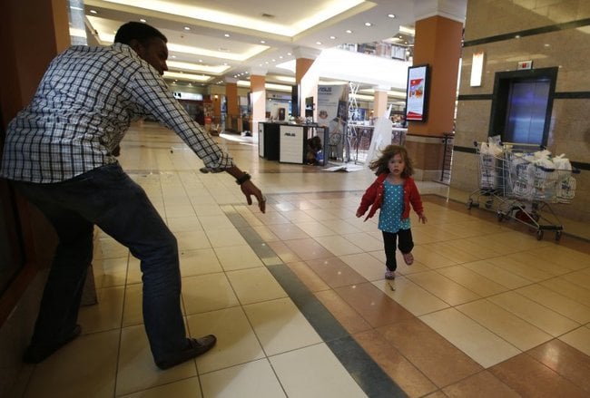 Little girl runs to police during Westgate shopping centre terrorist attack in Nairobi, September 21, 2013.