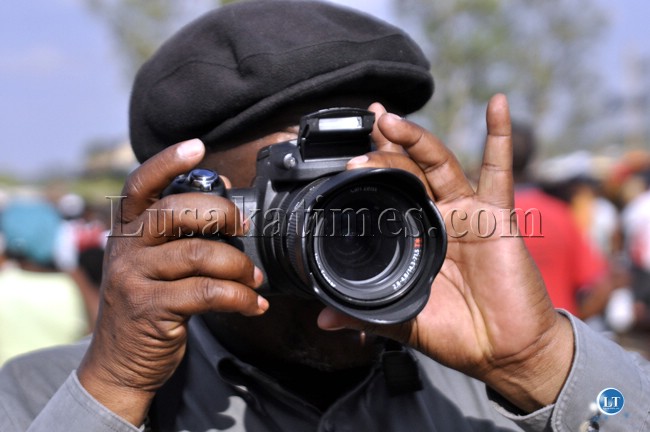 FILE: Human Rights activist Brebner Changala takes photographs at the UPND Mandevu Rally.