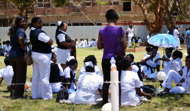 Protesting nurses at the University Teaching Hospital in Lusaka relax under a tree shade.